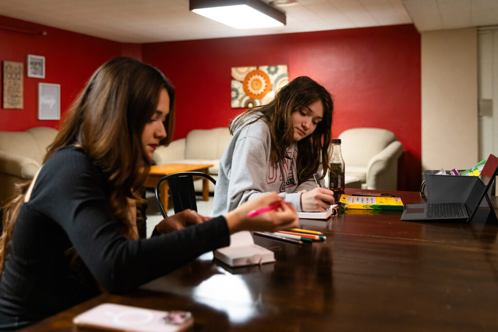 Photo of Elina Aparicio and Bianca Ybarbo journaling