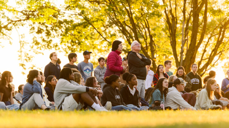 Photo of Buell and Kathy Fogg singing with students during a vespers at Holmes Lake Park.