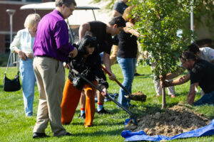 Photo of people planting a tree.