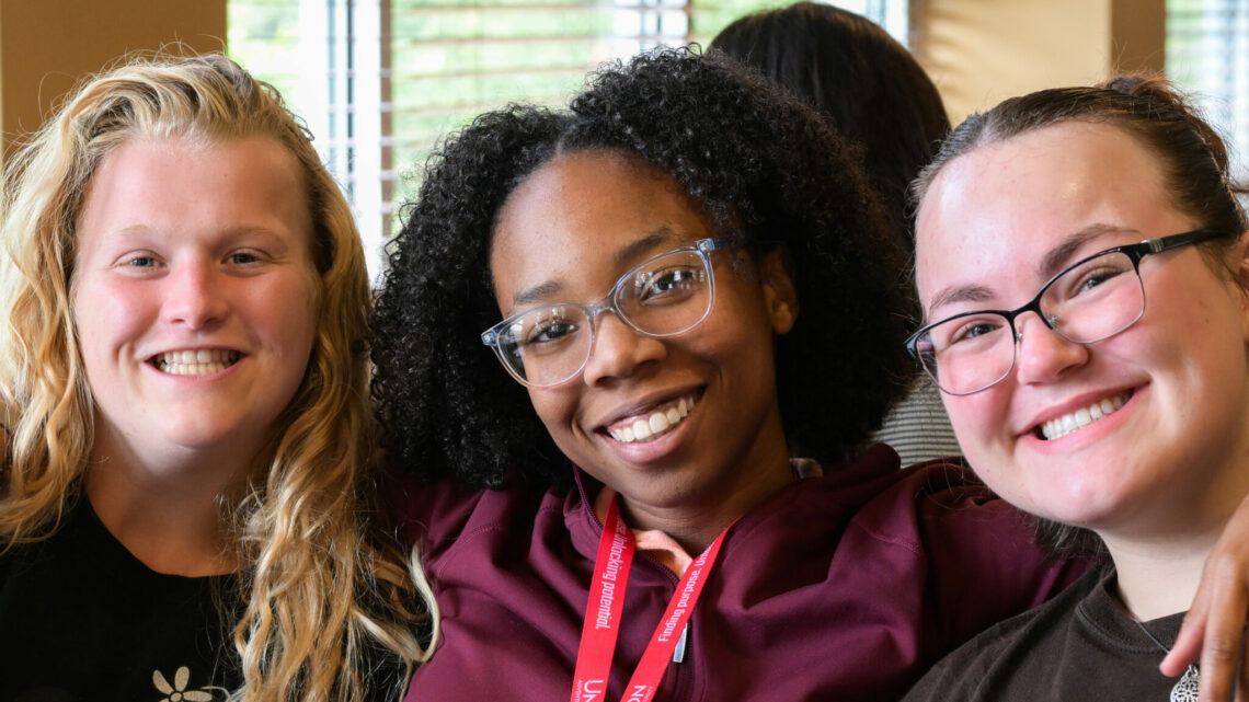 Photo of students Lanai Sanford, Katie Miller and Natalia Leffler eating in the cafeteria.