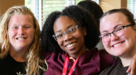 Photo of students Lanai Sanford, Katie Miller and Natalia Leffler eating in the cafeteria.